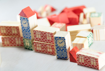 Wooden toy blocks to assemble with architectural and construction motifs on white background