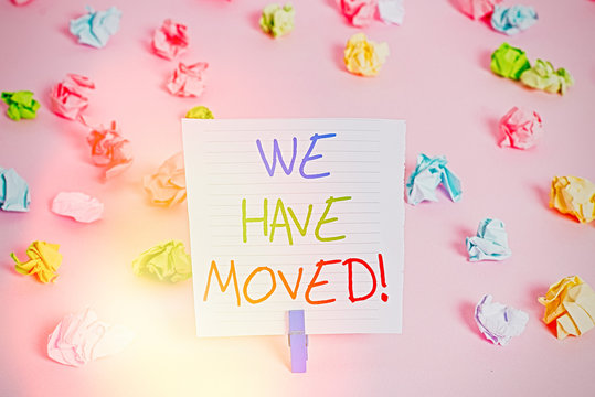 Conceptual hand writing showing We Have Moved. Concept meaning To go from one residence or location to another Relocate Colored crumpled papers empty reminder pink floor clothespin
