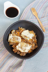 Buckwheat with fish in a black clay plate