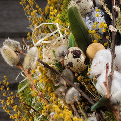 Wreath of dried twigs and flowers on a wooden background. Natural decoration. Celebration concept. Easter wreath. Willow round frame. Square.