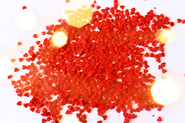 Minimalistic background for valentine's day with wavy little hearts on a white background. top view.