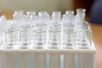 Empty glass test tubes in white plastic rack