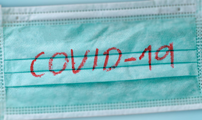 Medical face mask with covid-19 printed with blood. Coronavirus outbreak.