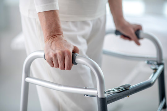Close up of a female hand holding on to the walker
