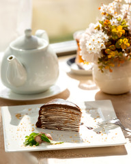 chocolate pancake cake on a white plate