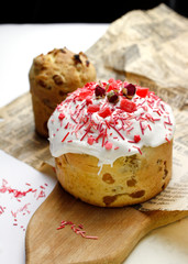 Glazed Easter cake decorated with flowers and food decorative elements on the table for the traditional Christian holiday Easter