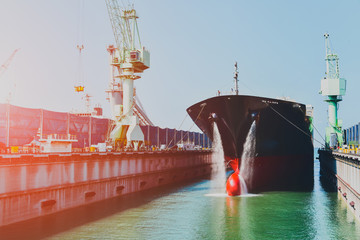 Shipyard cargo Ship repair in floating dock in sea water already from maintenance and repair...