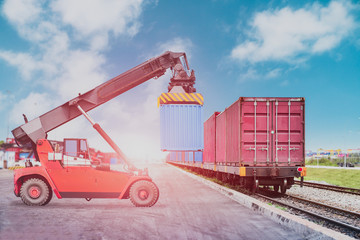 Forklift loading Container box to trains platform, Transport of cargos by rail in container, railway infrastructure Transport, Shipping import Export.