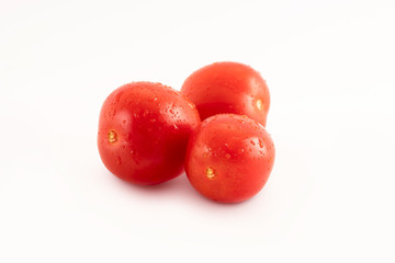 Fresh tomatoes with drops on a white background. Tomatoes with full depth of coldness