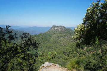 Natural landscape of rocky green mountain range view with clear blue sky