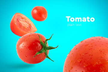 Fresh flying tomatoes on a blue background with drops. Tomatoes with full depth of coldness