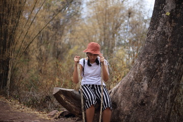 Woman sitting and resting at the bamboo forest in Phu Kradueng National Park, Loei, Thailand