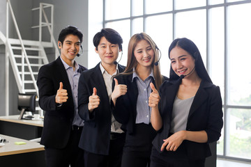 Obraz premium Asia Group of call center workers or Confident business team with headset in office.