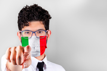 Man in mask with flag of Italy pointing at you. Stay at home concept.