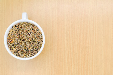 whole grain in a white bowl on wooden background. Healthy breakfast concept.
