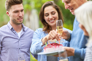 Woman decorates birthday cake with candles