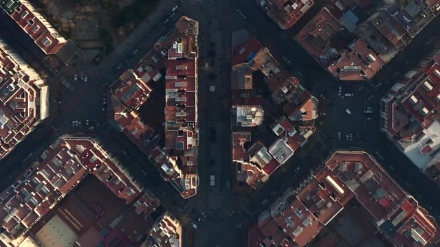 AERIAL: Barcelona Overhead Drone Shot of Typical City Blocks and La Sagrada Familia in Beautiful Sunlight with Urban Traffic 