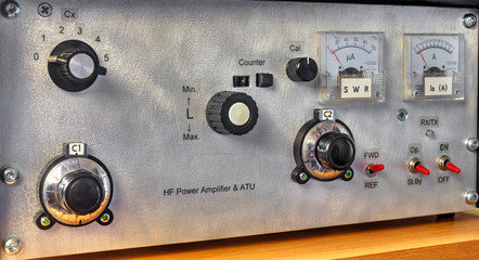 Front panel of a high frequency power amplifier with vacuum tubes close up view