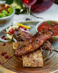 fried meat on sticks served with bread