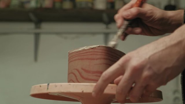 Ceramist work in the workshop.
