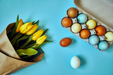 Bunch of yellow tulip flowers and Easter eggs. Happy Easter. Spring concept.
