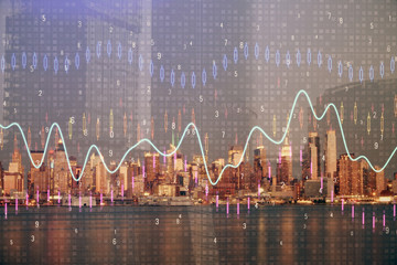 Naklejka premium Financial graph on night city scape with tall buildings background double exposure. Analysis concept.