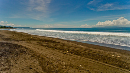 Fototapeta na wymiar Aerial view of black sand beach. A place to surf.