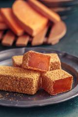 Pumpkin marmalade slices on vintage plate. Low shallow focus