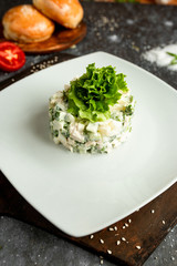 mayonnaise salad with lettuce on a white plate