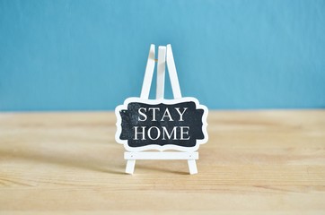 Social media awareness campaign and coronavirus prevention concept with word on blackboard"STAYHOME" isolated on darkblue background.