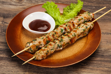 Minced pork skewer kebab with sauce