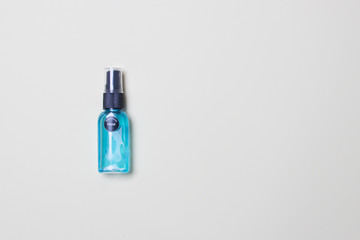 alcohol clean hand sanitizer in bottle on yellow colored paper background with copy space