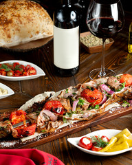 meat kebab on a ramrod with tomatoes wrapped in fat