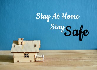 Social media awareness campaign and coronavirus prevention concept with word "STAY AT HOME STAY SAFE" isolated on darkblue background.