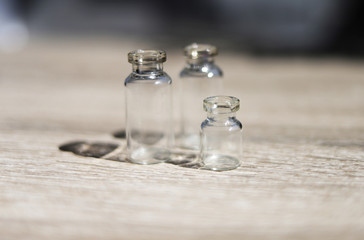 Transparent cosmetic bottles on a light background. Place for text. Front view.