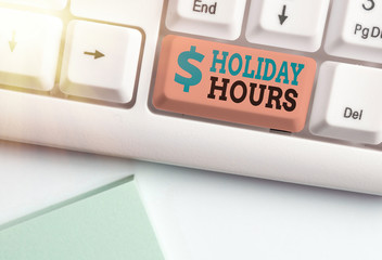 Writing note showing Holiday Hours. Business concept for employee receives twice their normal pay...
