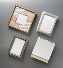 Empty, beautiful, photo frames and a stylish spiral Notepad on a gray background. Empty space. Mock-up. Stylized stock photos. The view from the top.