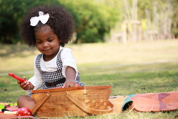 Dark skin kid play toy in the garden