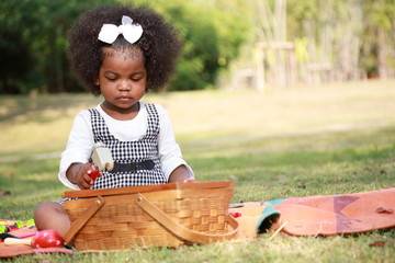 Dark skin kid play toy in the garden