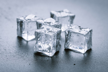 Pyramid of beautiful thawed ice cubes with drops of water