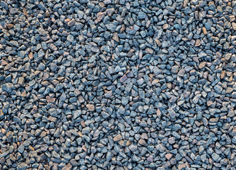 Crushed stone scattered on the ground. Large crushed stone for construction and repair work. Background, texture.