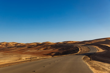 Fototapeta na wymiar Road through the desert to the Moreeb dune in Liwa Oasis, Emirate of Abu Dhabi, UAE