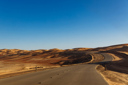 Road through the desert to the Moreeb dune in Liwa Oasis, Emirate of Abu Dhabi, UAE