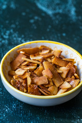 Healthy Organic Roasted Coconut Chips with Caramel Flavor / Caramelized Snacks.