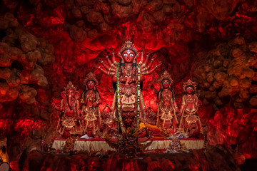 Idol of Goddess Devi Durga at a decorated puja pandal in Kolkata, West Bengal, India. Durga Puja is a popular and major religious festival of Hinduism that is celebrated throughout the world. - obrazy, fototapety, plakaty