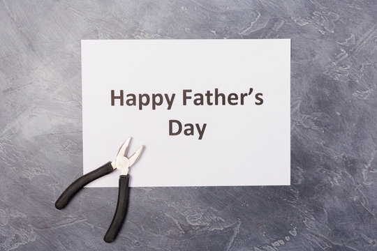 Happy father's day picture frame on black desk with pliers. Copy space. Holiday concept. Happy father 