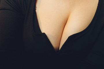 black short sweater with neckline female breast.