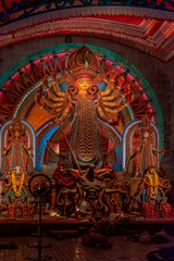 Fototapeta na wymiar Idol of Goddess Devi Durga at a decorated puja pandal in Kolkata, West Bengal, India. Durga Puja is a popular and major religious festival of Hinduism that is celebrated throughout the world.