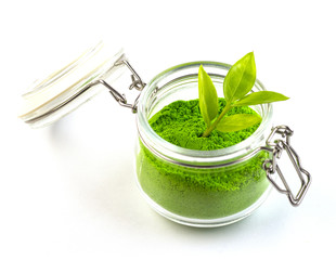 dry green tea powder matcha tea with whole leaves, isolate on a white background