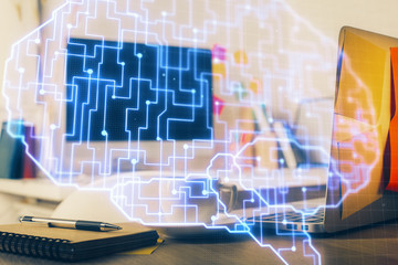 Double exposure of work space with computer and human brain drawing hologram. Brainstorm concept.